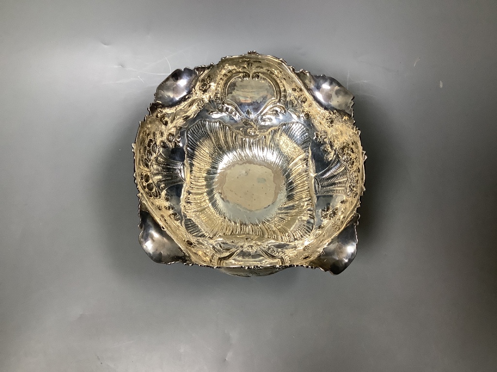 A late Victorian embossed silver fruit bowl, decorated with scrolls, baskets of fruit and masks, by Walter & John Barnard